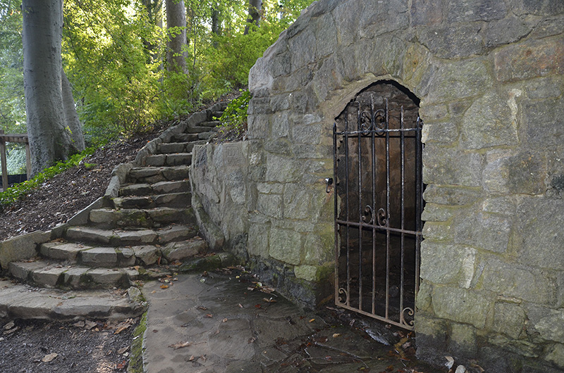 At the foot of a stone stairway built in 1934, a 19th century spring house overlooks the Reflection Garden at Falls Park.